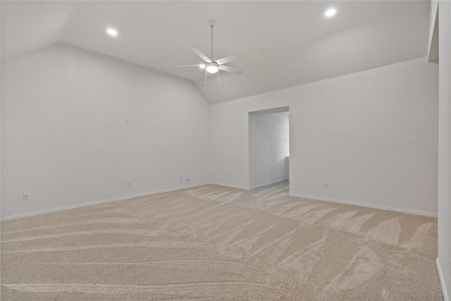 spare room featuring recessed lighting, light carpet, a ceiling fan, baseboards, and vaulted ceiling