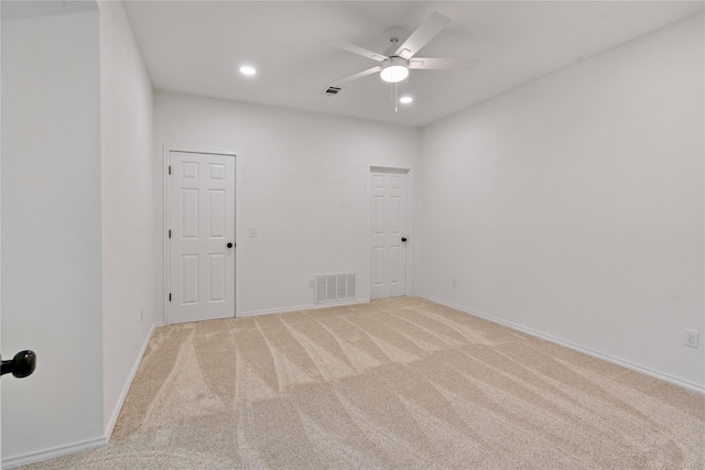 empty room featuring visible vents, baseboards, light colored carpet, ceiling fan, and recessed lighting