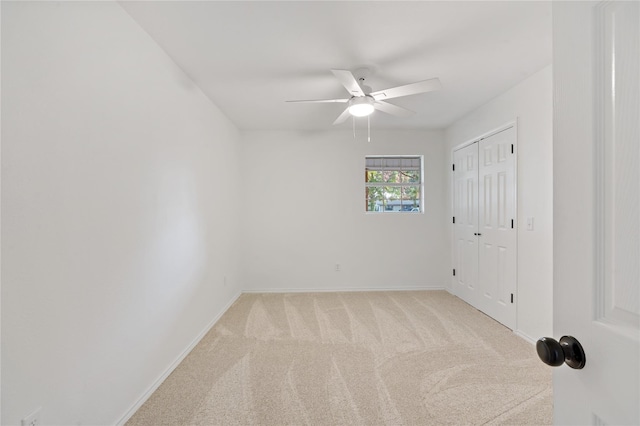 empty room with ceiling fan, carpet floors, and baseboards