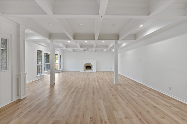 unfurnished living room with light wood-style flooring, a fireplace, coffered ceiling, beamed ceiling, and ornate columns