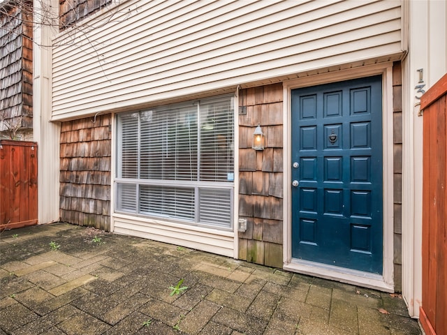 view of exterior entry featuring a patio