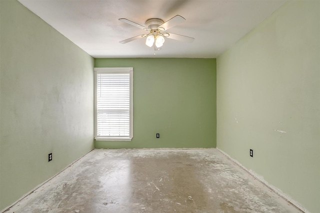 empty room with ceiling fan and unfinished concrete floors