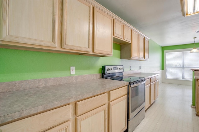 kitchen with hanging light fixtures, stainless steel range with electric stovetop, light countertops, and light brown cabinetry