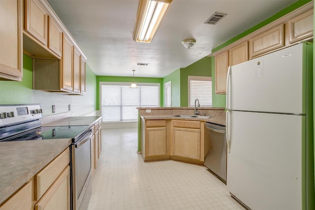 kitchen featuring light brown cabinets, visible vents, stainless steel appliances, and a sink