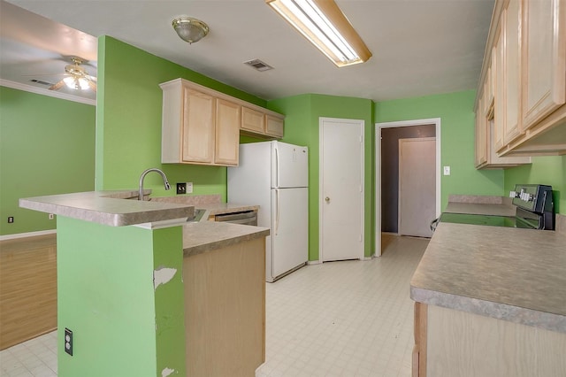 kitchen featuring light floors, stainless steel appliances, visible vents, light brown cabinets, and a peninsula