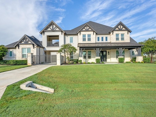 view of front of property featuring metal roof, concrete driveway, stone siding, a standing seam roof, and a front yard