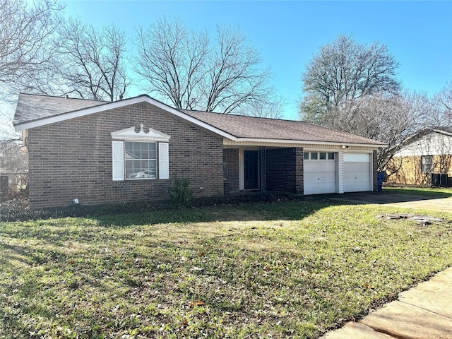 view of front of home featuring brick siding, a shingled roof, an attached garage, a front yard, and driveway