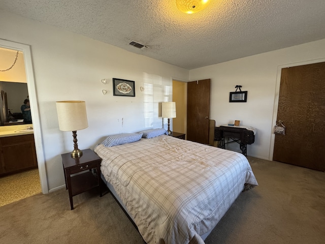 carpeted bedroom with visible vents and a textured ceiling