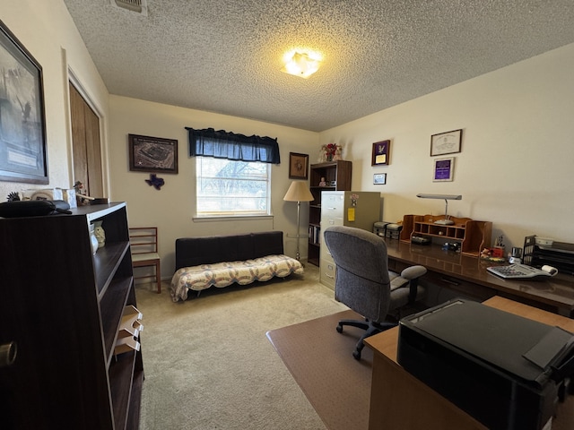 home office with carpet and a textured ceiling