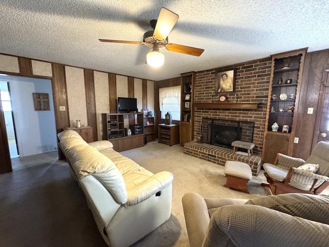 living area featuring visible vents, a ceiling fan, light colored carpet, a textured ceiling, and a brick fireplace