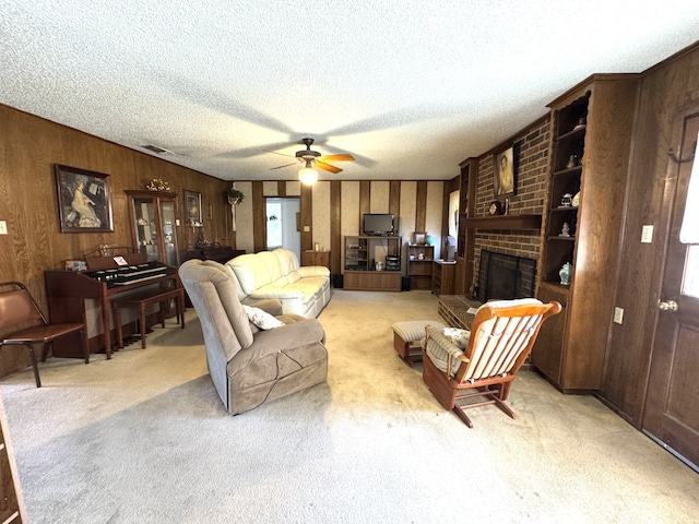 living room featuring light colored carpet, visible vents, a fireplace, and a textured ceiling