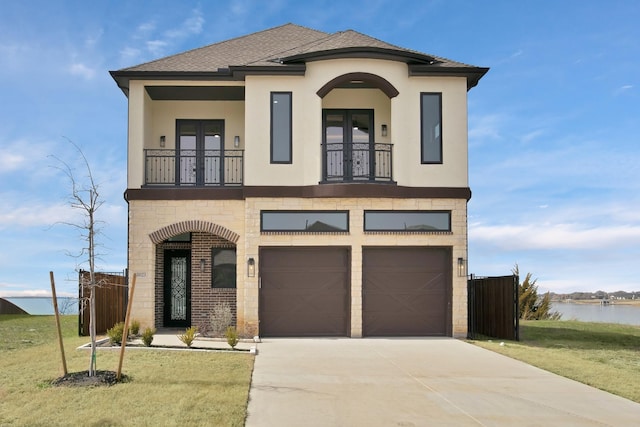 view of front of home featuring a balcony, stucco siding, fence, and french doors