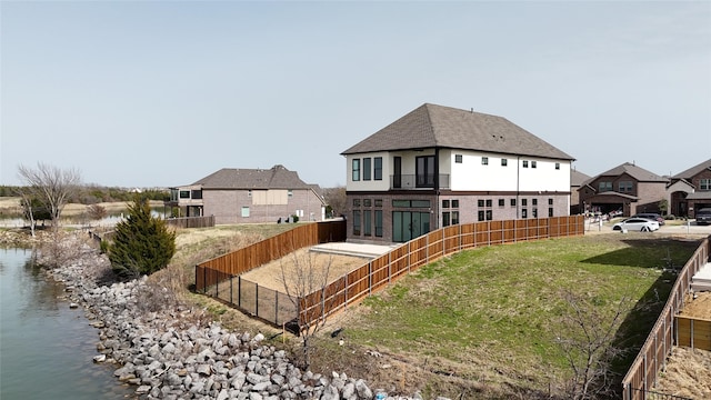 view of yard with a water view and fence