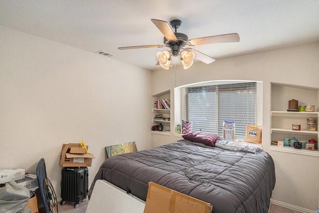 carpeted bedroom with baseboards, radiator heating unit, visible vents, and a ceiling fan