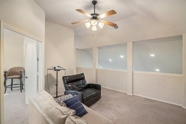 living area featuring vaulted ceiling, carpet floors, visible vents, and a ceiling fan