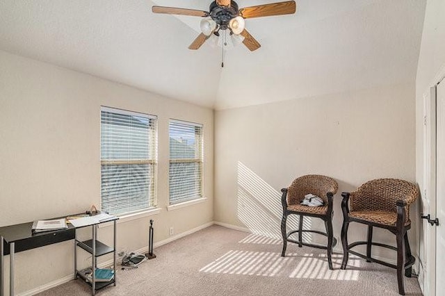 carpeted office space featuring vaulted ceiling, baseboards, and ceiling fan