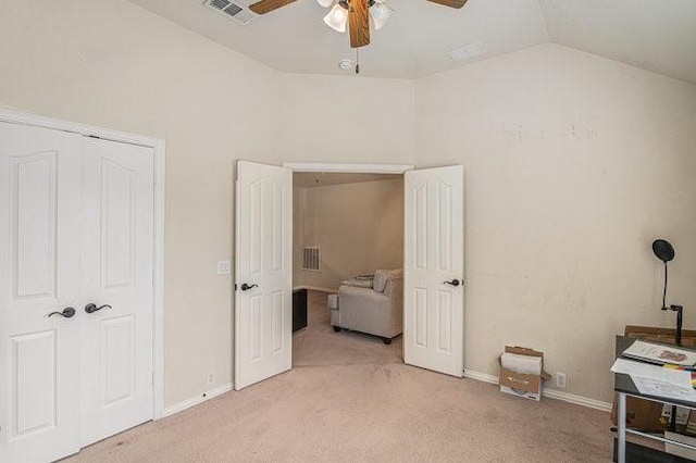 bedroom featuring light carpet, ceiling fan, visible vents, and vaulted ceiling