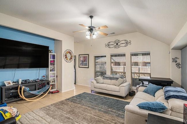 tiled living area featuring baseboards, visible vents, vaulted ceiling, and a ceiling fan