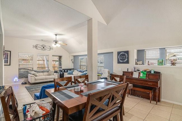 dining space featuring vaulted ceiling, light tile patterned floors, and a wealth of natural light