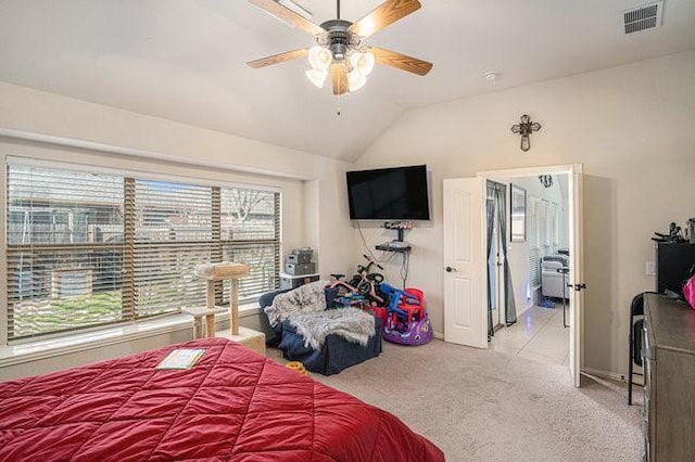 bedroom featuring a ceiling fan, lofted ceiling, light carpet, and visible vents