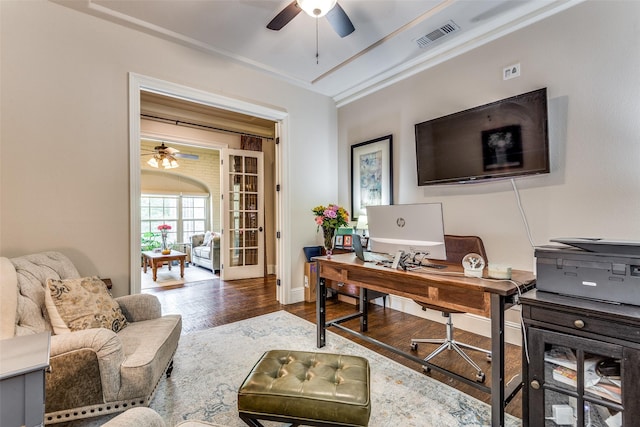 office space featuring baseboards, ceiling fan, visible vents, and wood finished floors