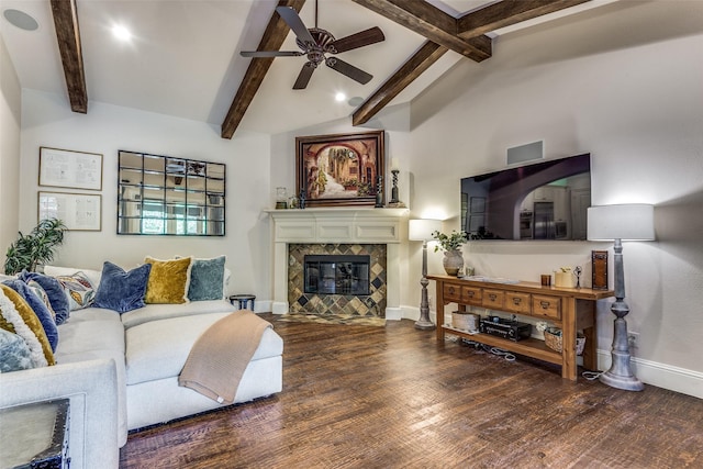 living area with ceiling fan, a fireplace, wood finished floors, baseboards, and beamed ceiling