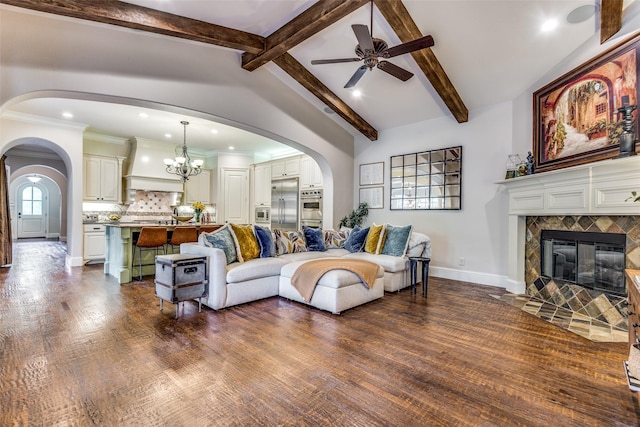 living area featuring a tile fireplace, dark wood-style flooring, arched walkways, and lofted ceiling with beams