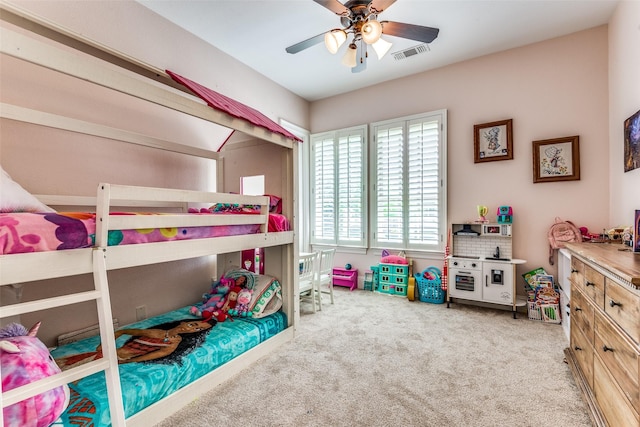 carpeted bedroom featuring ceiling fan and visible vents