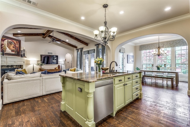 kitchen featuring lofted ceiling with beams, a fireplace, a sink, dishwasher, and green cabinetry