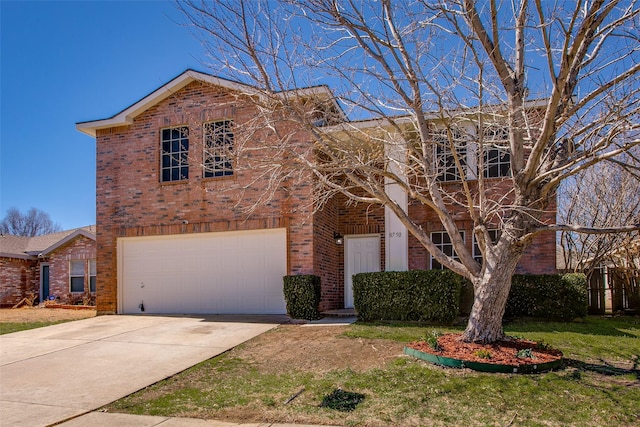 view of front of home with driveway, a front yard, a garage, and brick siding