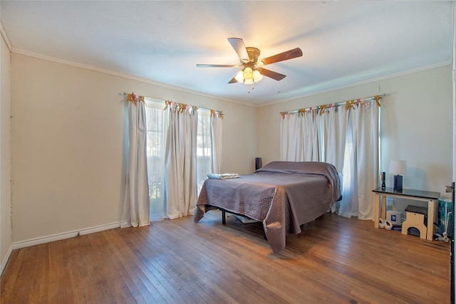 bedroom with ceiling fan, ornamental molding, and hardwood / wood-style flooring