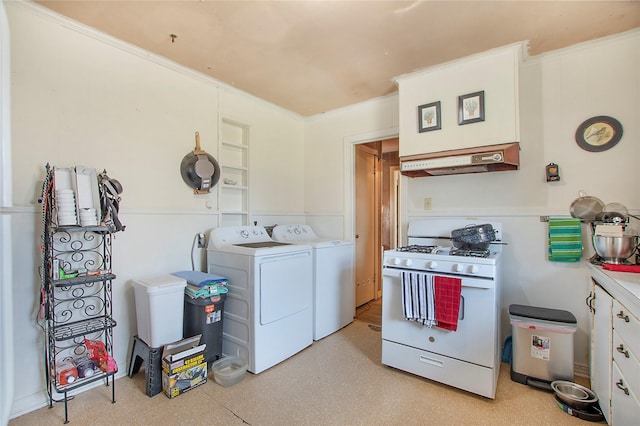 clothes washing area featuring laundry area and washer and clothes dryer