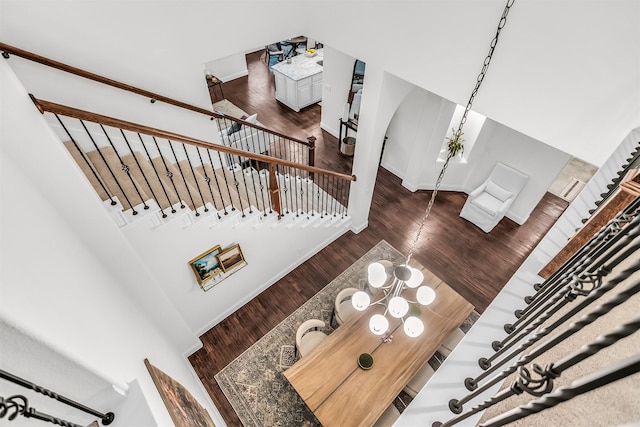 stairway featuring wood finished floors and baseboards