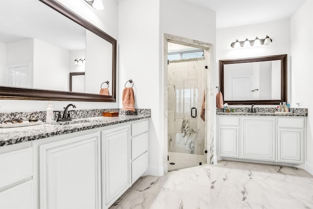 bathroom with marble finish floor, two vanities, a sink, and a marble finish shower