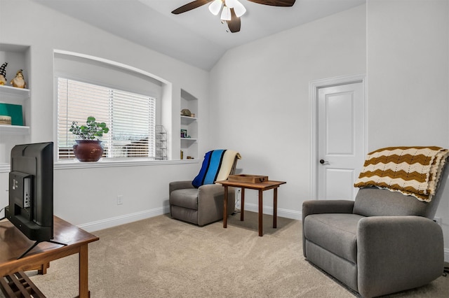 sitting room with a ceiling fan, carpet, vaulted ceiling, and baseboards