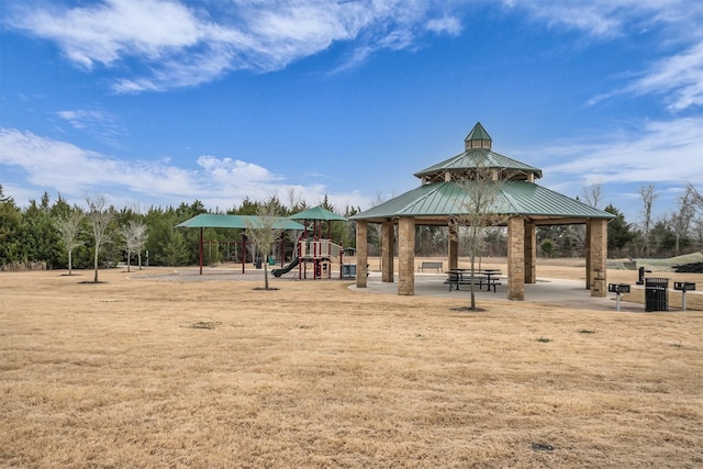 view of property's community with a lawn, playground community, and a gazebo