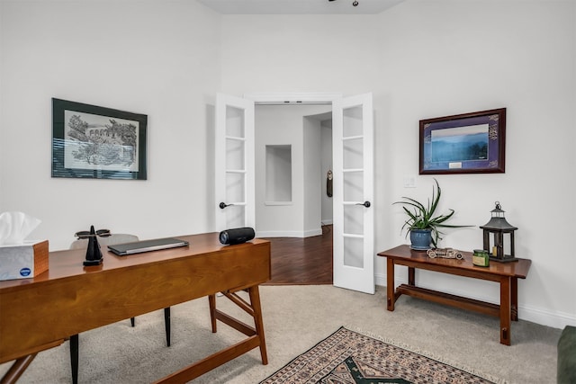 office space with carpet floors, baseboards, and french doors