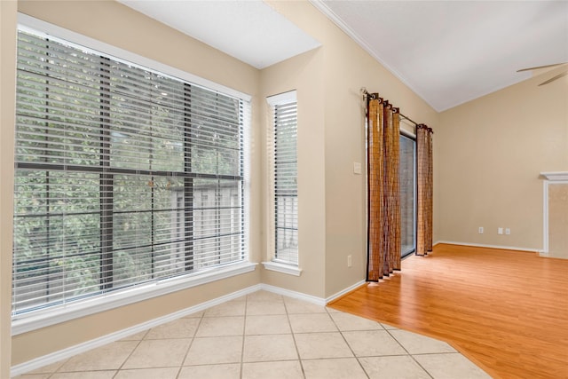 spare room featuring light wood-style floors, crown molding, and a wealth of natural light