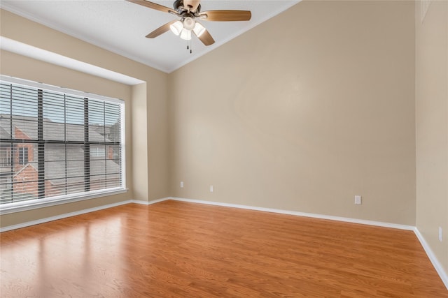 empty room with light wood finished floors, baseboards, ornamental molding, and a ceiling fan