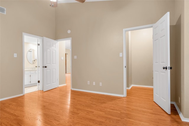 unfurnished bedroom with visible vents, light wood-style flooring, and baseboards