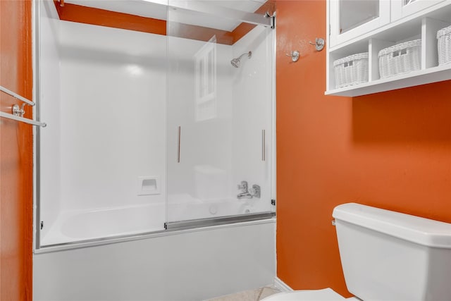 bathroom featuring enclosed tub / shower combo and toilet