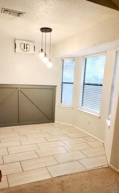 829 Lake Crest Pkwy, Azle, TX 76020 - unfurnished dining area with a textured ceiling and baseboards