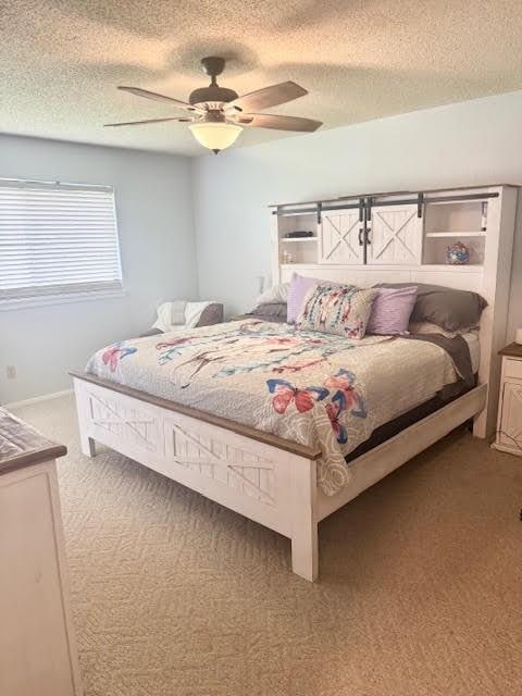 829 Lake Crest Pkwy, Azle, TX 76020 - carpeted bedroom with a textured ceiling and ceiling fan