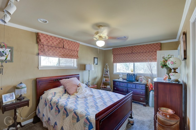 1106 Bryan St, Minden, LA 71055 - carpeted bedroom with a ceiling fan, multiple windows, visible vents, and crown molding
