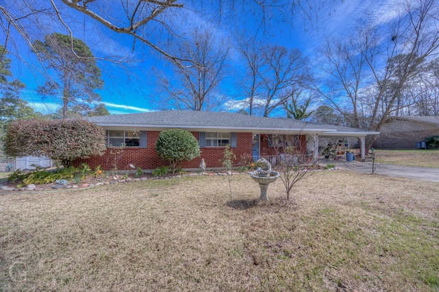 ranch-style house featuring aphalt driveway, an attached carport, brick siding, and a front lawn