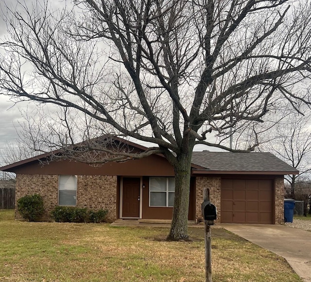 single story home featuring a garage, brick siding, driveway, and a front yard