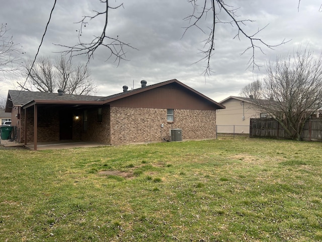 back of property featuring a patio, a yard, fence, and brick siding