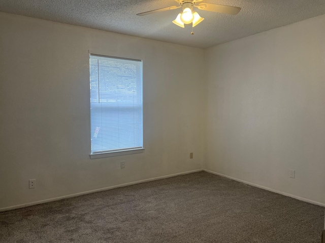 spare room with carpet floors, ceiling fan, a textured ceiling, and baseboards