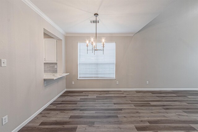 unfurnished dining area with wood finished floors, visible vents, and baseboards