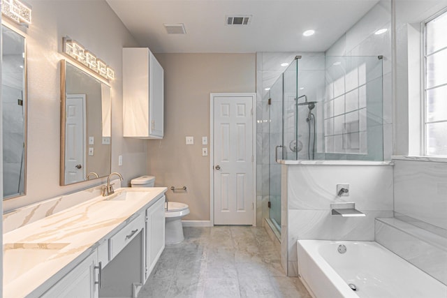 bathroom with double vanity, a stall shower, visible vents, toilet, and a garden tub